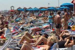 Romanos y turistas en la playa de Ostia